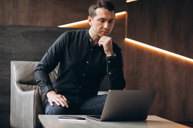 Handsome business man working on computer in office