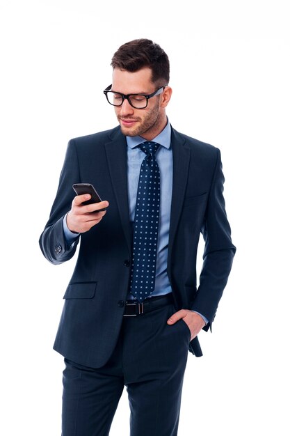 Handsome businessman checking emails on the phone