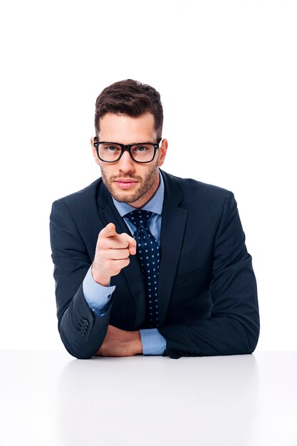 Handsome businessman pointing to the front