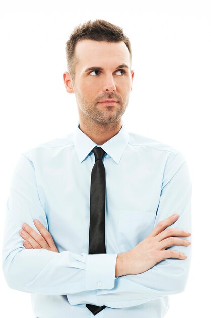 Handsome businessman with arms crossed looking away