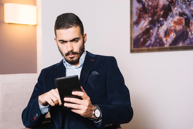 Handsome businessman with tablet