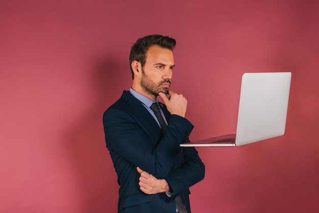 Handsome businessman working in a laptop