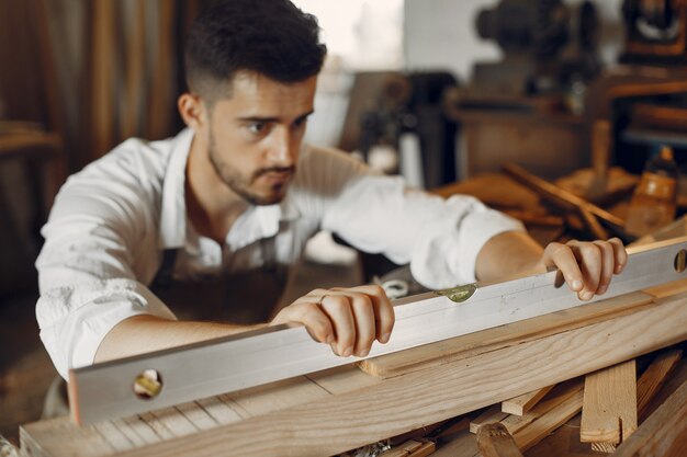 Handsome carpenter working with a wood