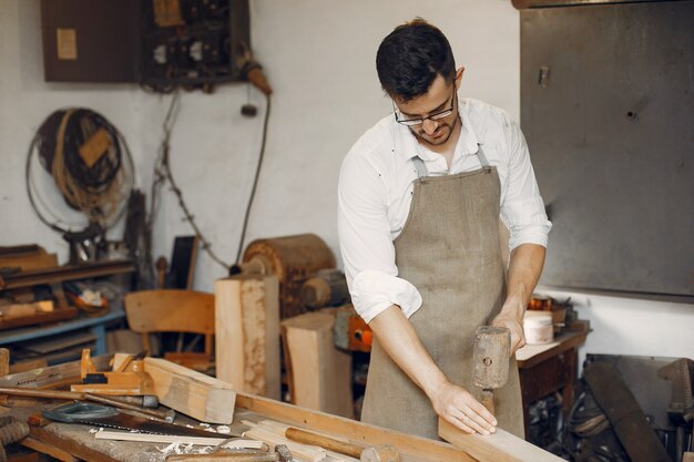 Handsome carpenter working with a wood