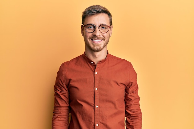 Free photo handsome caucasian man wearing casual clothes and glasses with a happy and cool smile on face. lucky person.