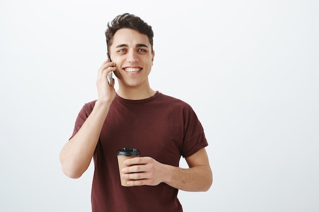 handsome cheerful guy talking by phone