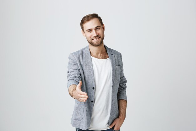 Handsome confident man stretch hand for handshake