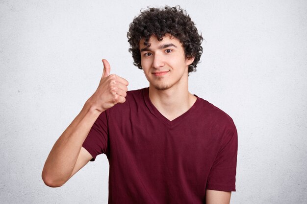 Handsome curly male with delighted expression