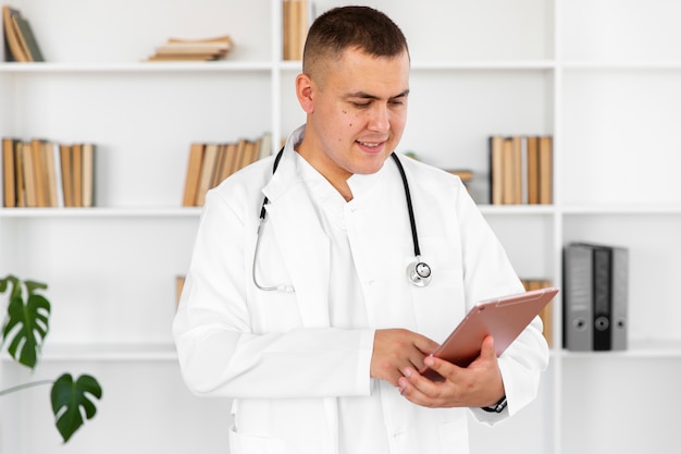 Handsome doctor holding a clipboard