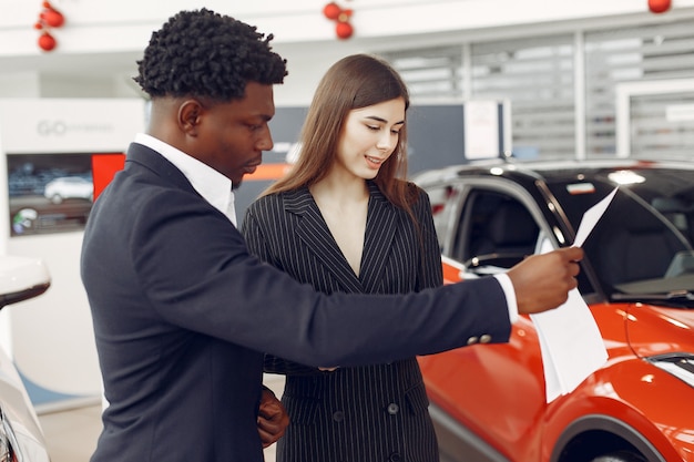 Handsome and elegant black man in a car salon