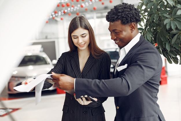 Free photo handsome and elegant black man in a car salon