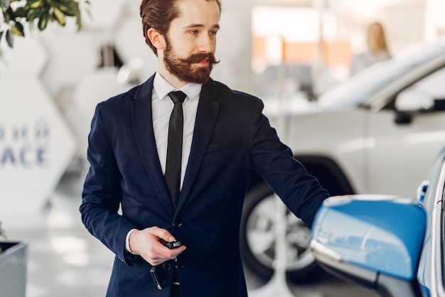 Handsome and elegant man in a car salon