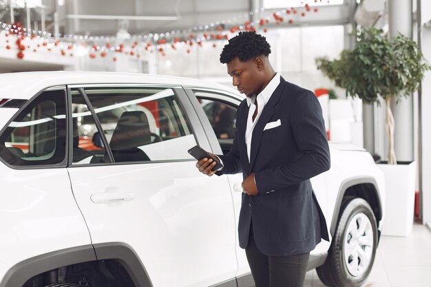 Handsome and elegant man in a car salon