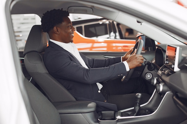 Handsome and elegant man in a car salon