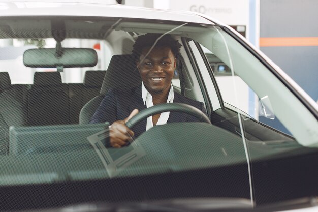 Handsome and elegant man in a car salon