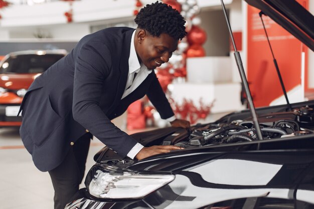 Handsome and elegant man in a car salon