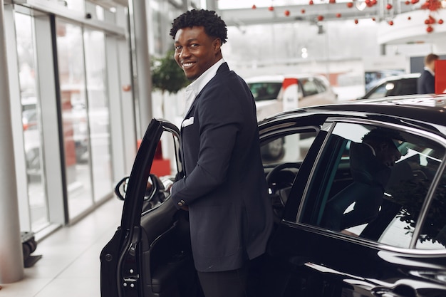 Handsome and elegant man in a car salon