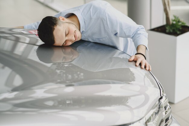 Handsome and elegant man in a car salon