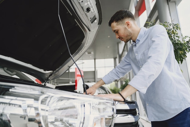 Handsome and elegant man in a car salon