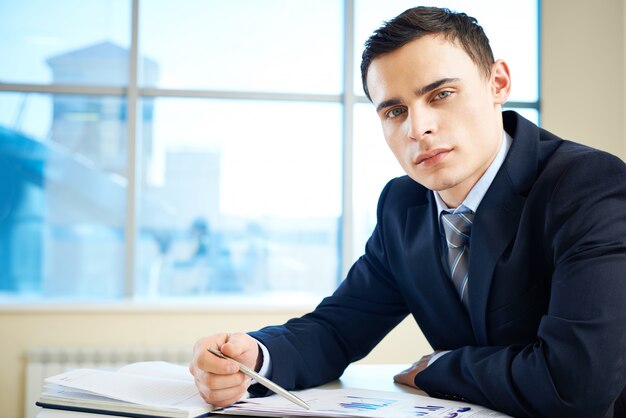 Handsome executive working with business reports