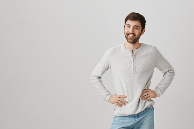 Handsome friendly bearded guy smiling at front