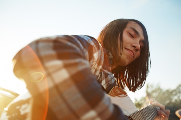 Handsome Guitarist Enjoying Summer Day