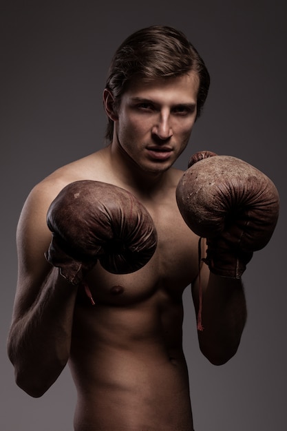 Free photo handsome guy in a boxing gloves