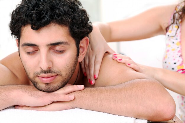 Handsome guy enjoying massage therapy