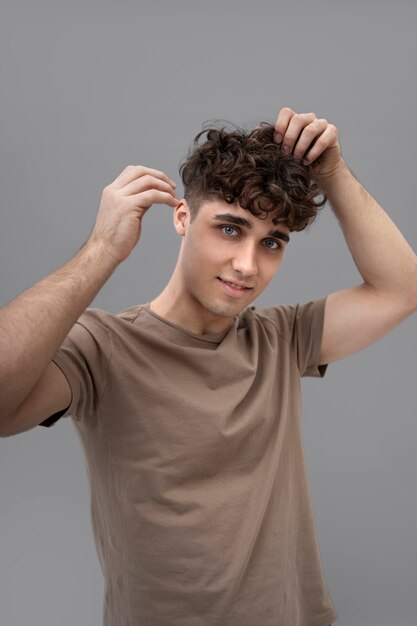 Handsome guy fixing his curly hair