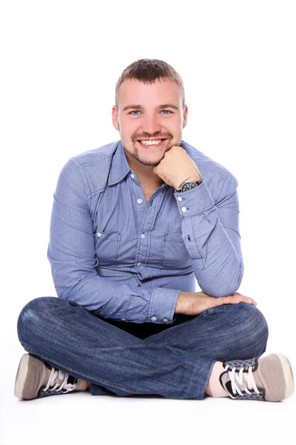 Handsome guy sitting on the floor