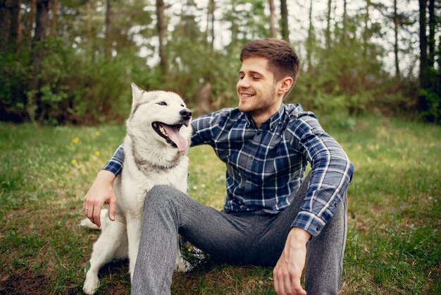 Handsome guy in a summer park with a dog