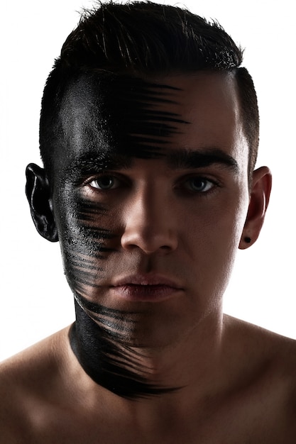 Handsome guy with artistic black shadow on his face 