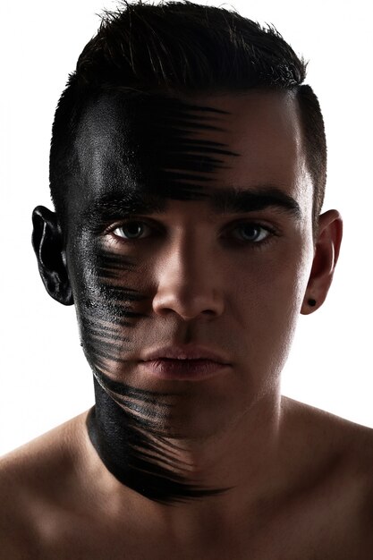 Handsome guy with artistic black shadow on his face 