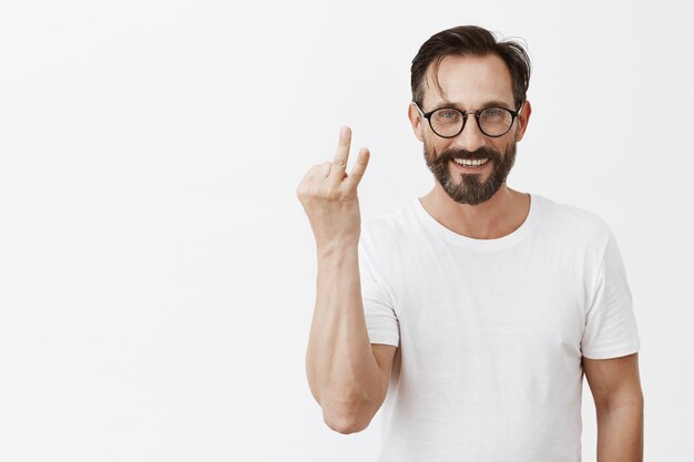 Handsome happy bearded mature man with glasses posing