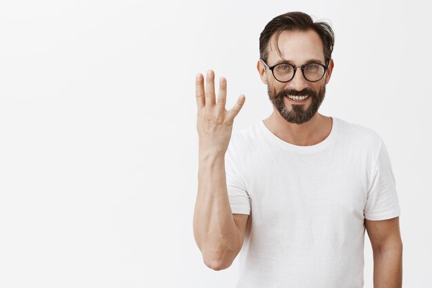 Handsome happy bearded mature man with glasses posing