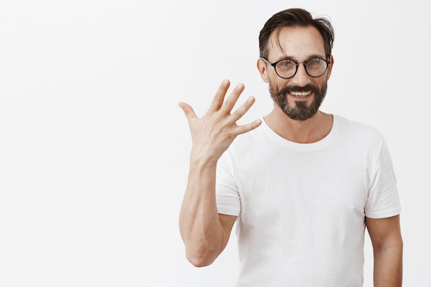 Handsome happy bearded mature man with glasses posing