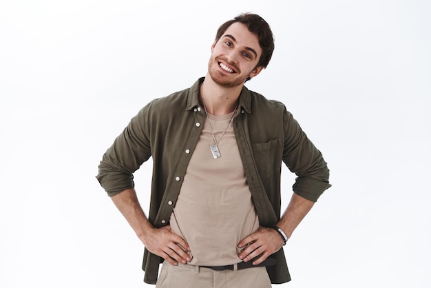 Handsome happy boyfriend tilt head and looking pleased camera satisfied shopping with girlfriend at mall checkingout outfit agree with good choice standing delighted white background