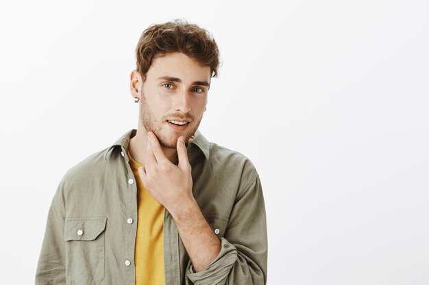 Handsome happy man posing in the studio