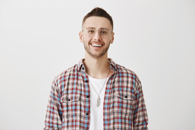 Handsome happy young guy with glasses posing