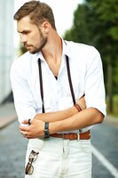 handsome hipster model man in stylish summer clothes posing