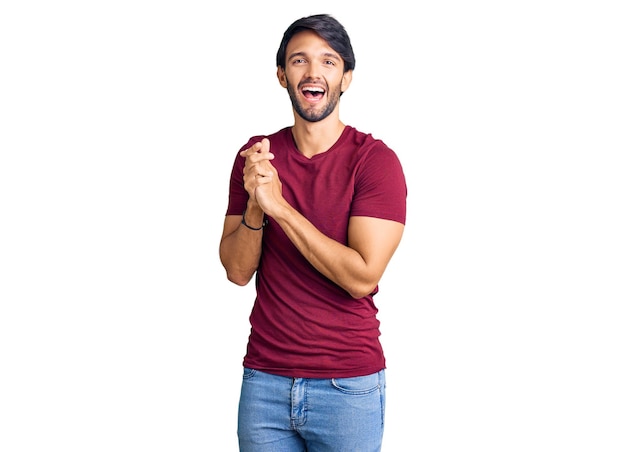 Handsome hispanic man wearing casual clothes clapping and applauding happy and joyful, smiling proud hands together