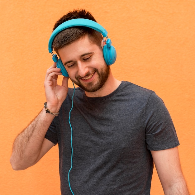 Free photo handsome male listening music in headphones