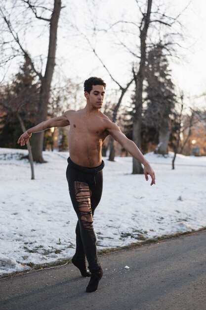 Handsome male performing ballet outdoor