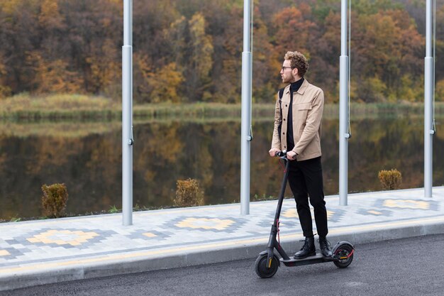 Handsome male riding an electric scooter