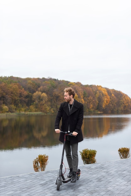 Handsome male riding an electric scooter