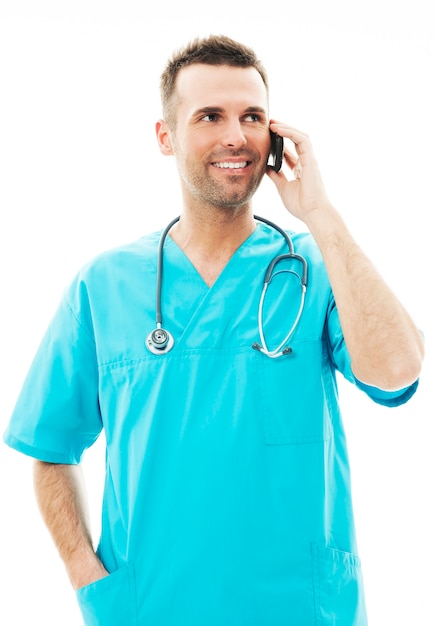 Handsome male surgeon talking on a mobile phone