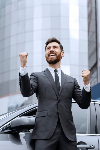 Handsome male taxi driving standing next to his cab