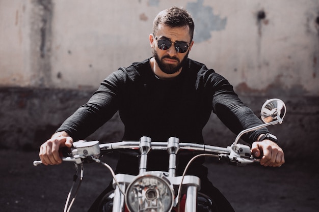 Handsome man biker travelling on mototrcycle