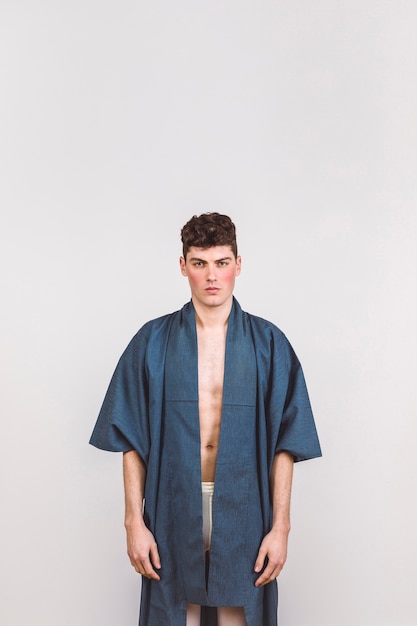 handsome man in blue robe with white background