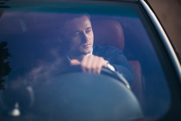 Handsome man by car